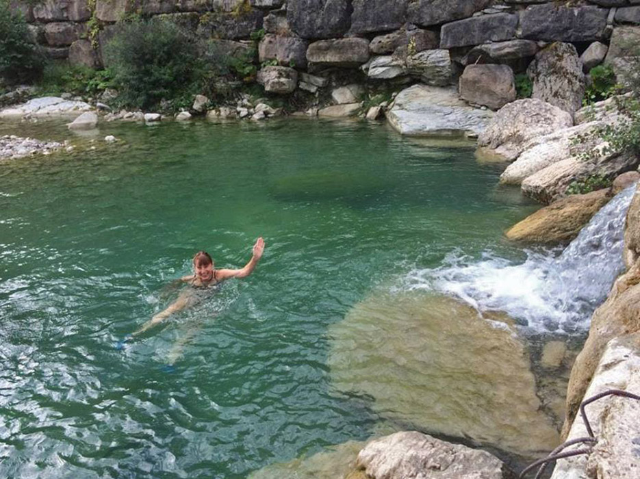 The author swimming in a pool in the river